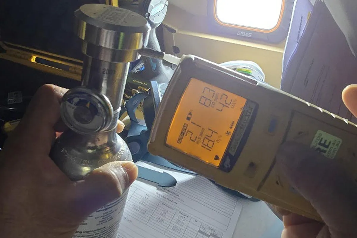 Four-gas detection device being calibrated before confined space entry