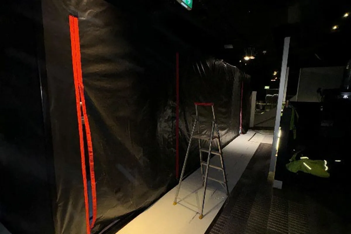 Containment sheeting installed across the work zone