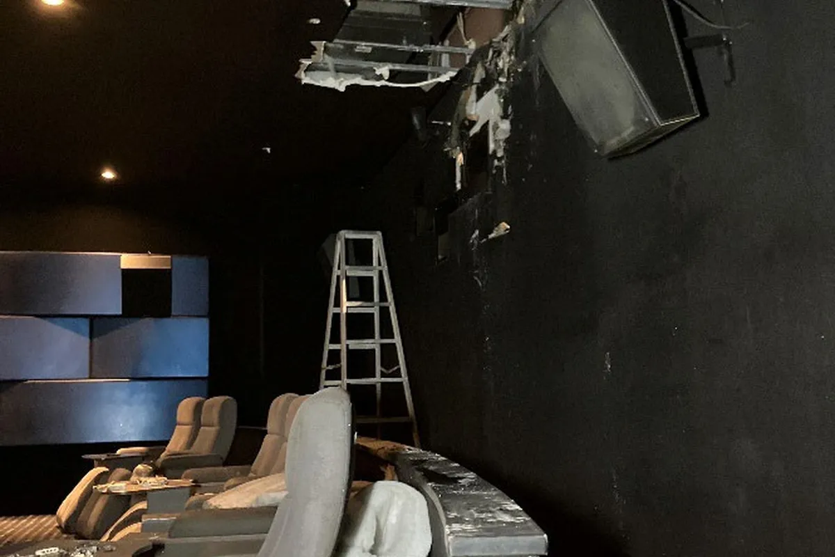 Fire and water damaged cinema auditorium with seating removed