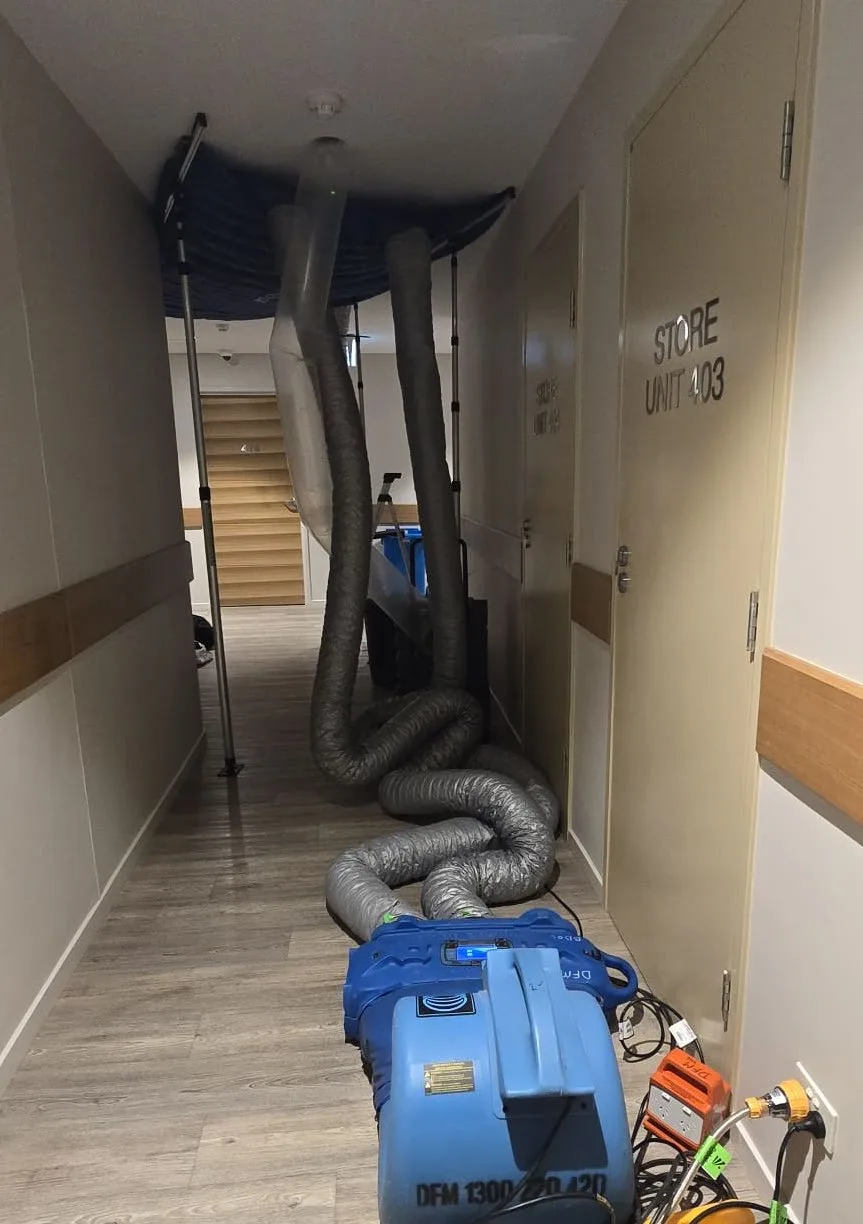 Ducted drying equipment running through an affected residential corridor