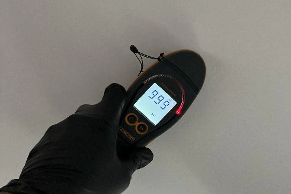 Moisture meter reading taken against an affected wall