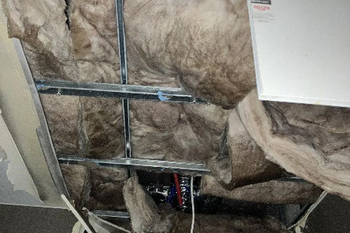 Wet ceiling insulation exposed during strip-out works
