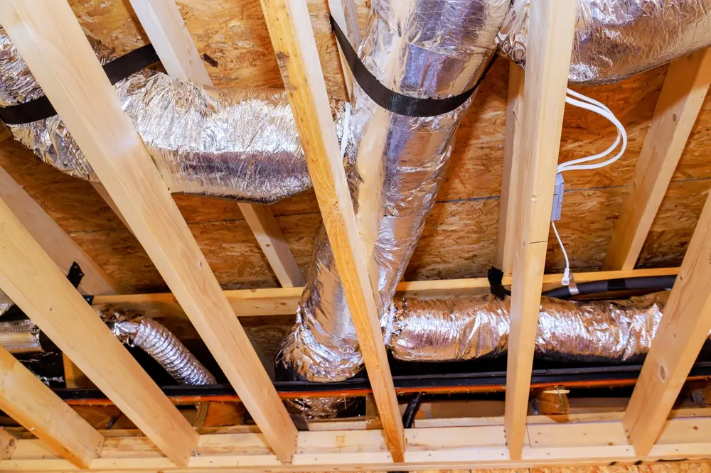 Sub-floor ventilation ducting installed beneath a home's floor joists.